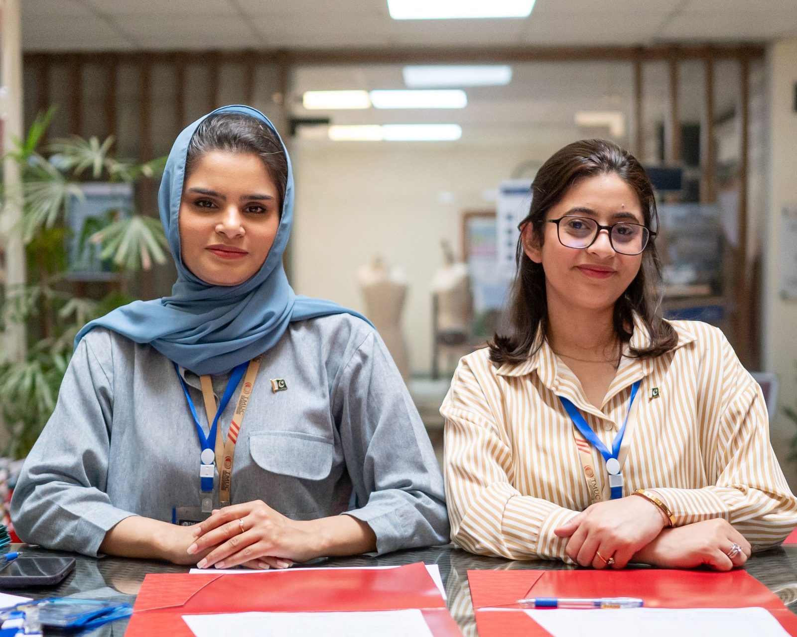 Two case workers at their desk in an Islamabad office